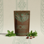 Azomalli Cacao Tea Peppermint Brew package with cacao beans and pepeprmint  and spearmint leaves on a patterned background
