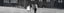 Black-and-white image of Paola’s three children, holding hands and walking away from the camera towards their house.