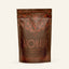 A 1.32oz packet of Azomalli Cacao Spice Cacao tea, dark brown with orange-brown text and animal imagery, on white background.